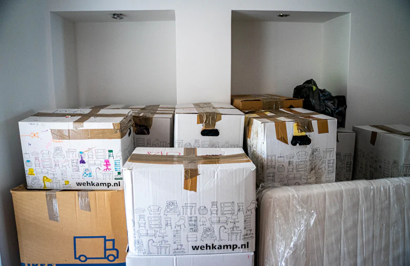 Packed moving boxes stacked in an empty room
